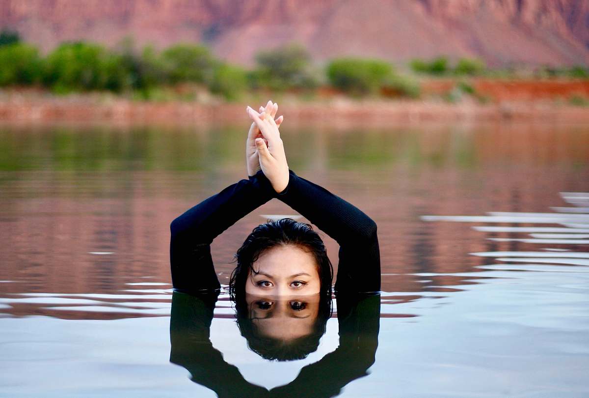 working out shallow focus photo of person swimming in water during daytime sport